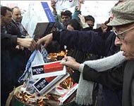 Anti-US demonstrators burnAmerican-made cigarettes