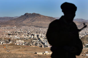 Soldier stands on hill outside Sanaa