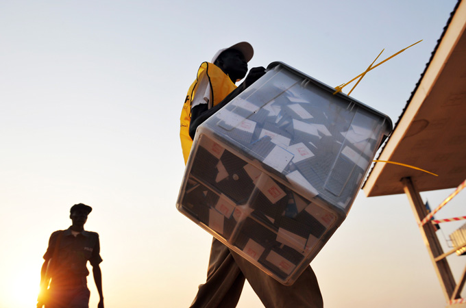 soldiers escort election officials with ballot boxes