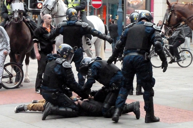 riot police in UK surround a guy