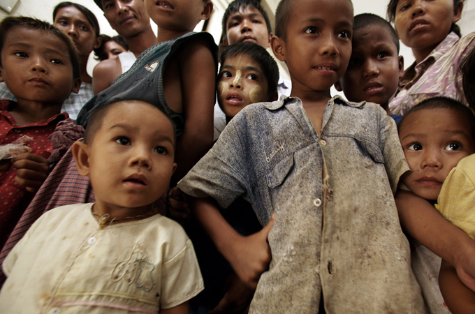 YAUKTAN, MYANMAR - MAY 14: Burmese children wait for aid supplies at the refugee camp as aid begins to arrive following last week's Cyclone,, on May 14, 2008, in Kyauktan (south east of Yangon),