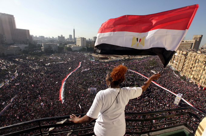 Woman waving flag at Tahrir