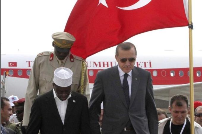 Turkey''s PM Erdogan and Somalia''s President Ahmed walk from the podium after their national anthems were played in Mogadishu