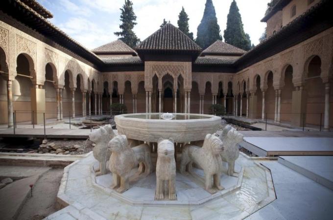 Water flows from the Lion Fountain in the Court of Lions at Alhambra Palace in Granada