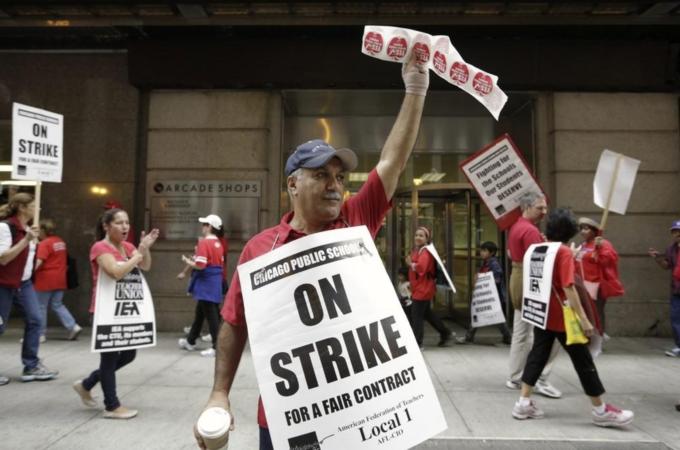 Chicago Teachers Union member and Math teacher Pera pickets outside the CPS headquarters in Chicago