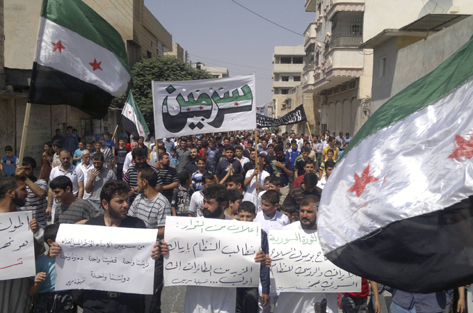 Syria Demonstrators hold Syrian opposition flags