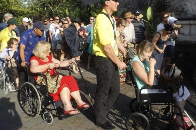 Survivors of the 2002 Bali bomb blast are pushed in on wheelchairs for the commemoration service for the 10th anniversary of the Bali bombing in Garuda Wisnu Kencana (GWK) cultural park in Jimbaran