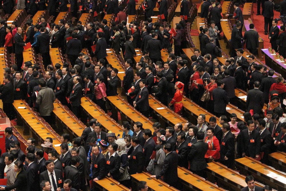 Chinese Communist Party delegates line up in order to leave the Great Hall of the People on the last day of its National Congress. The congress, which began on November 8, solidified the party(***)s once-in-a-decade leadership change.