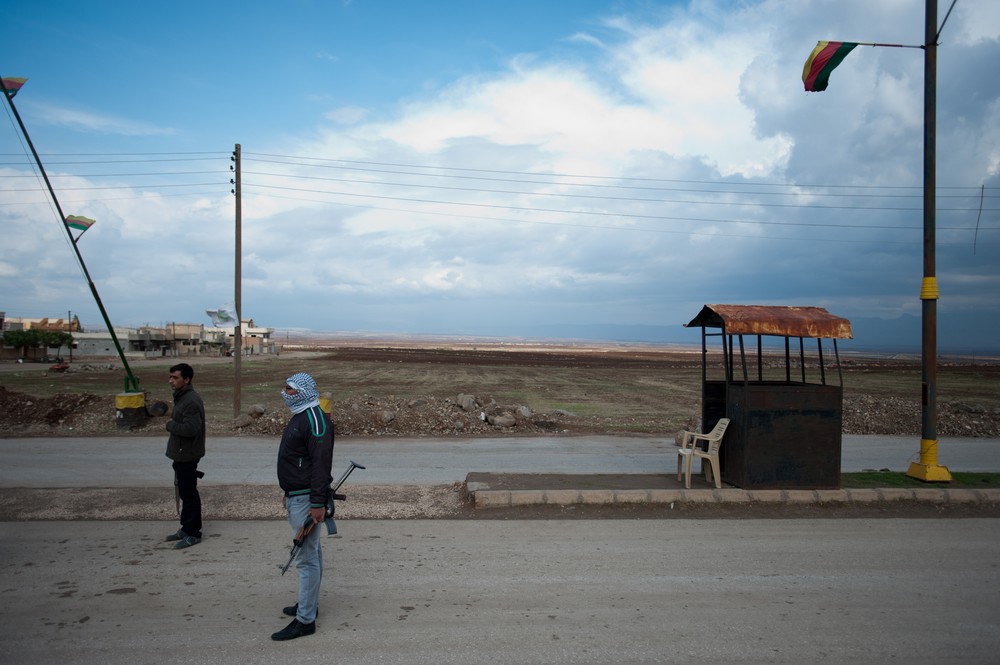 Members of a Kurdish local self-defence group man a checkpoint on the road to Derik, Syria.