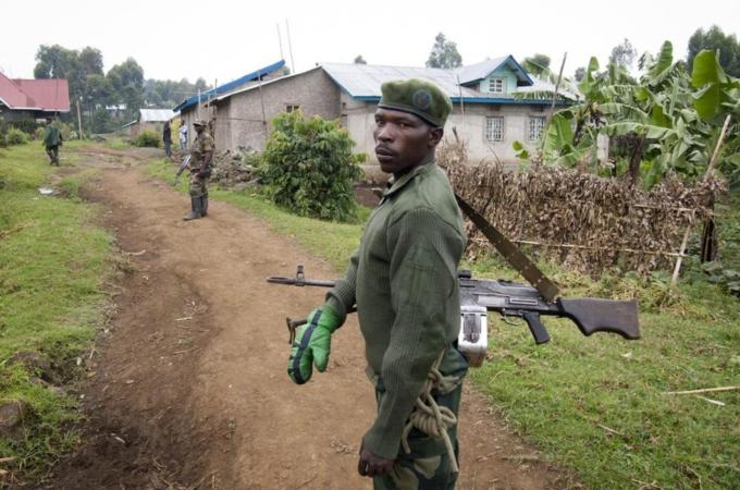 An M23 Rebel fighter looks on as he mans