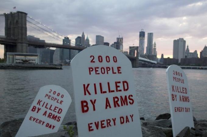 Fake tombstones are placed along the East River by members of the Control Arms Coalition to coincide with a diplomatic conference on the future Arms Trade Treaty in New York