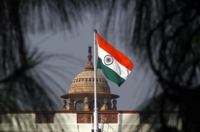 An Indian national flag flutters on top of the Indian parliament building in New Delhi