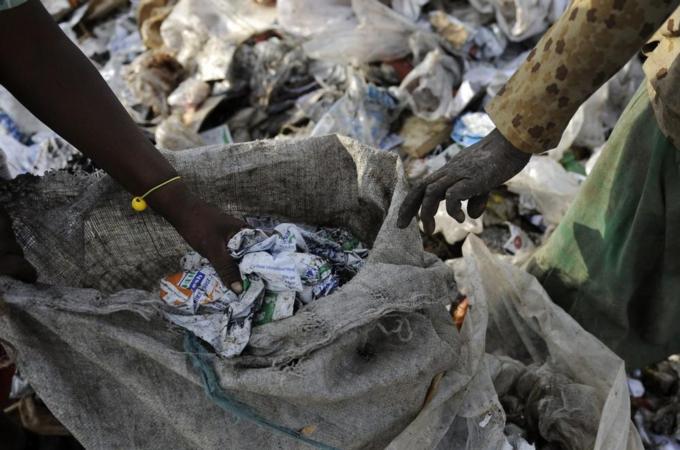 A woman receives some money after scaven