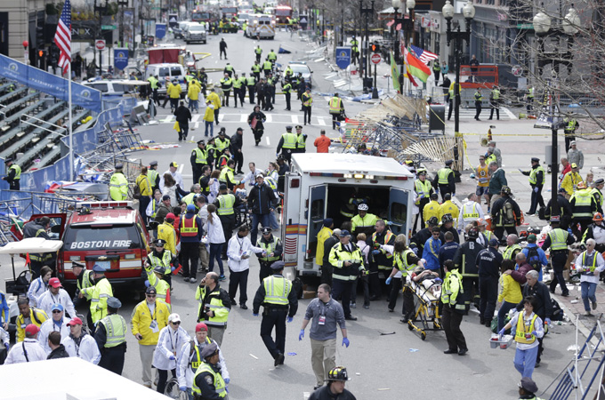 Medical workers aid injured people at the finish line of the 2013 Boston Marathon