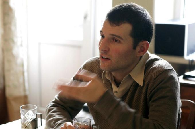 Blogger Adnan Hajizade chats with friends at his home in Baku