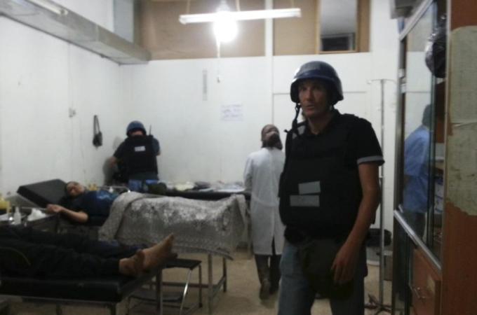 U.N. chemical weapons experts visit wounded people affected by an apparent gas attack, at a hospital in the southwestern Damascus suburb of Mouadamiya