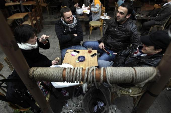 Syrians sit at a cafe in the old city of
