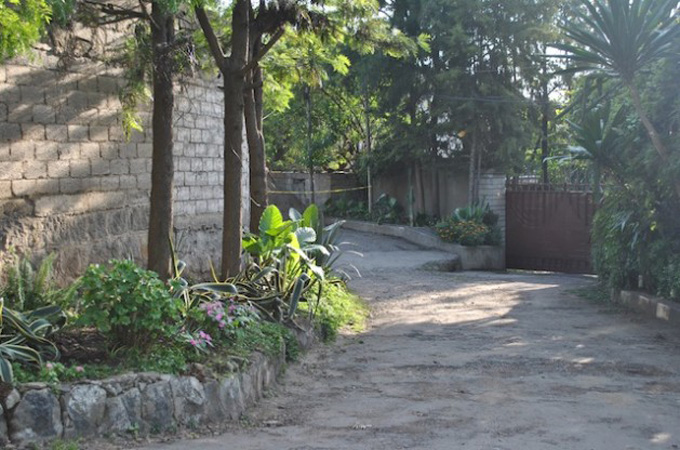 Police tape marks the compound where a bomb explosion killed two Somali men [Jacey Fortin/IPS]