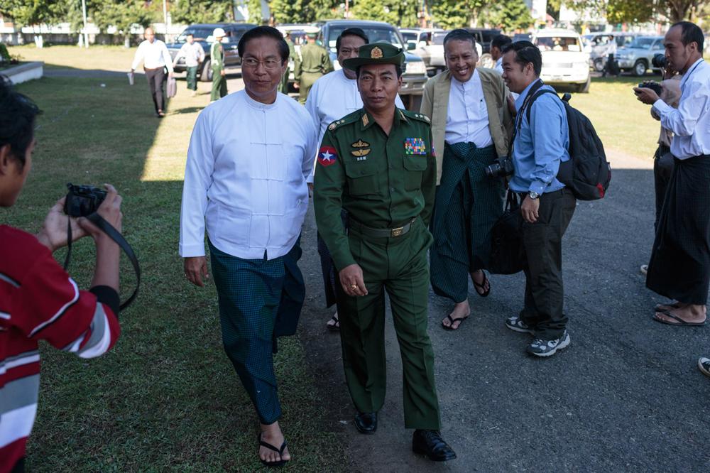 <p>Lieutenant General Myint Soe of the Myanmar army is ushered into the first day of meetings between the military and rebel groups over the possible implementation of a ceasefire agreement in Myitkyina, Myanmar on November 4.</p>