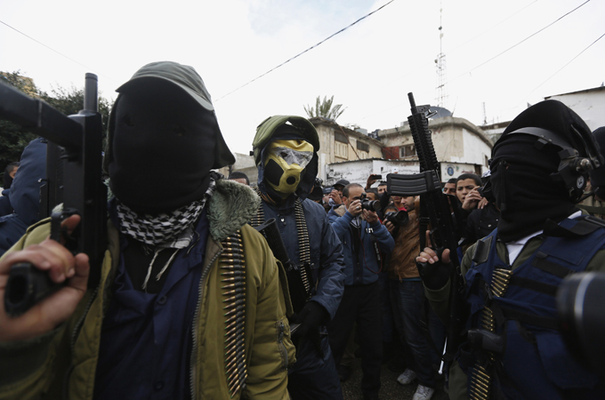 Masked Palestinians attend the funeral of 15-year-old Wajih Wajdi al-Ramahy who was shot dead [Reuters]