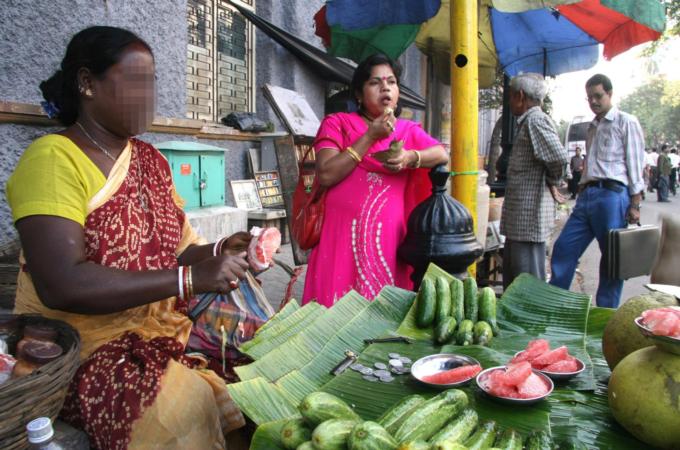 A Muslim street vendor in Kolkata dresses up as a Hindu to attact buyers [Shaikh Azizur Rahman /Al Jazeera]