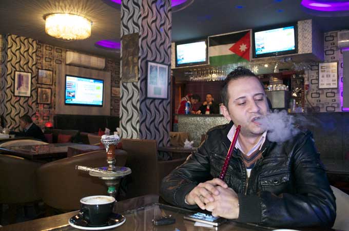Ashraf al-Jerres says that, if the ban is enforced, he will have to close his four cafes [Elizabeth Whitman/Al Jazeera]