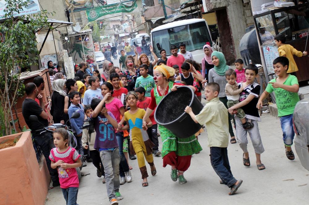 The clowns paraded through the streets of the Shatila refugee camp with children and other camp residents.