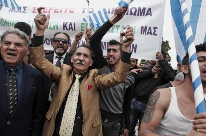 Ethnic Roma Greek protesters shout slogans during a demonstration in front of the Greek Parliament in Athens [EPA]