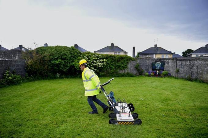 An engineer uses ground-penetrating radar on the suspected site of a mass grave of almost 800 children [EPA]