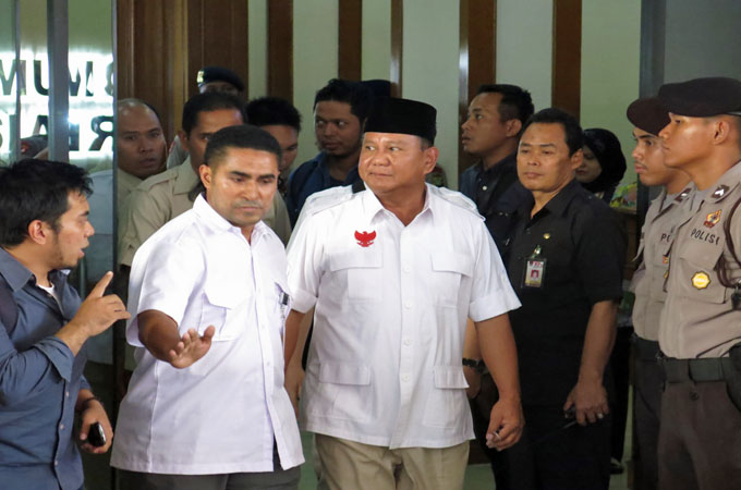 Indonesia's Prabowo Subianto (centre) is supported by hard-line groups, but his campaign states a commitment to pluralism [Al Jazeera]