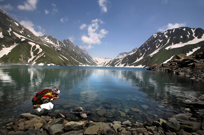 Critics say pilgrimages have led to a speedier melting of ice, cutting of trees, and littering [Altaf Qadri - EPA]