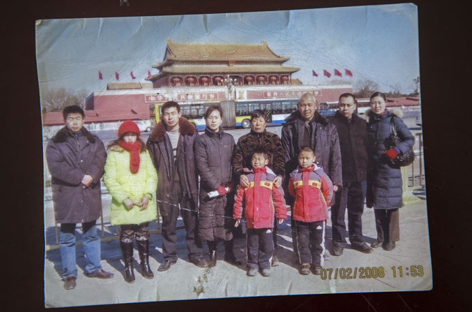 A photo taken in front of the Forbidden City in 2008 shows Lamung Bawk Din (second from left) standing next to her husband (far left) and his family [Taylor Weidman/Al Jazeera]