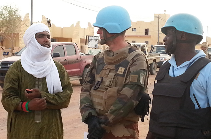Moussa Ag Assarid, left, chats with French soldiers in Kidal in June 2014 [Kingsley Kobo/Al Jazeera]