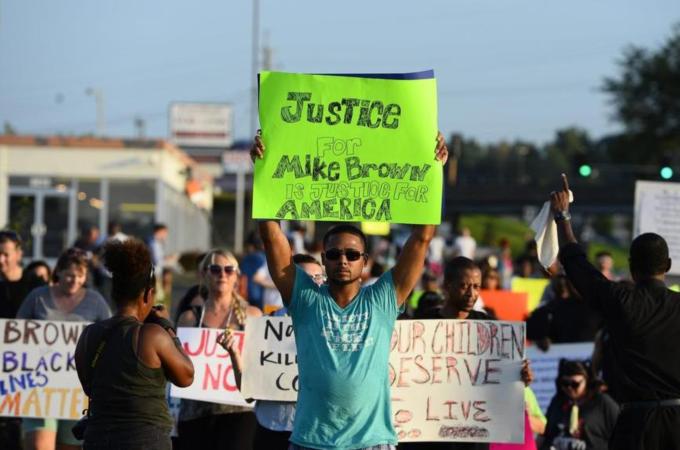 Police 'pacified' the protests over the shooting of Mike Brown in Ferguson in the same manner as they 'pacified' the riots in Brazil, writes Baboulias [EPA]