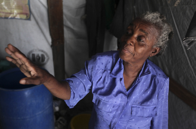 With the help of her neighbours, Thelia St. Louis was able to piece together her dwelling [Daniel Morel/Al Jazeera]