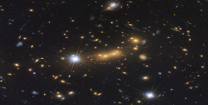 Cluster MACSJ0647, shown here, acts as a super-massive zoom lens on ancient remote galaxies [NASA/Dan Coe]