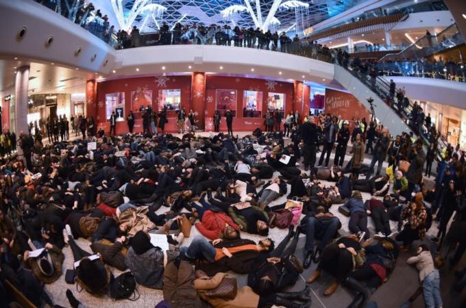 Protesters create a 'die-in' at the Westfield shopping mall in West London [AFP]