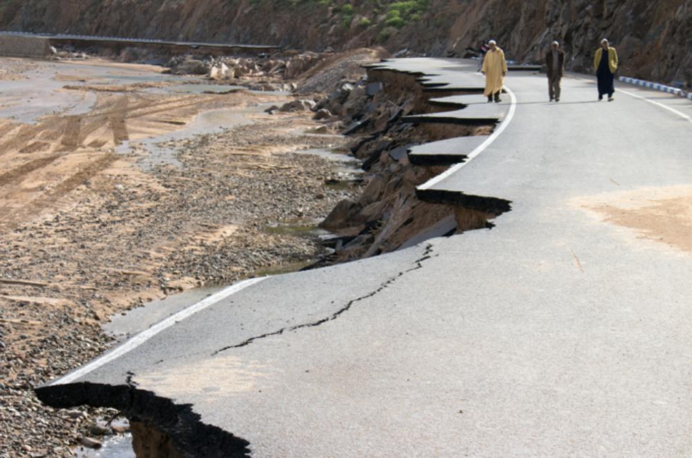Men walking by the main road between Sidi Ifni and Guelmim that was completely destroyed by the floods. 
