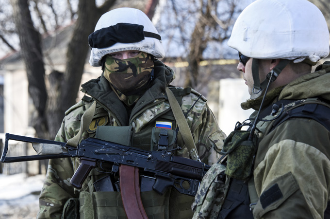 Pro-Russia rebels stand on guard near the Donetsk airport after attempting to seize it [AP]