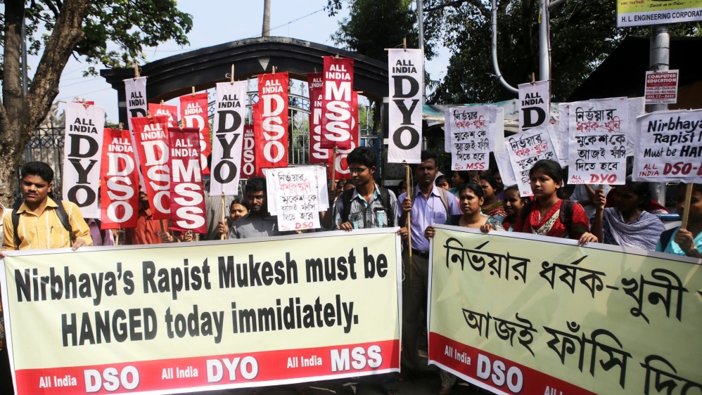 Activists hold placards during a protest demanding urgent death penalty for convicted gang-rapist, in Calcutta, India [EPA]