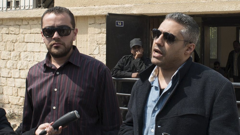 Al Jazeera television journalists Fahmy and Mohamed speak to the media outside of a court in Cairo