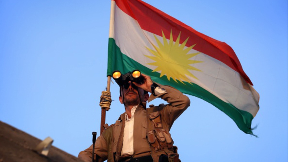 A Kurdish Peshmerga fighter uses binoculars as he holds a position on the front line in the Gwer district, 40 kilometres south of Arbil [Getty]