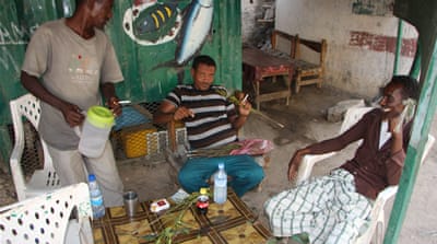 Men gather during a hot afternoon to chat and chew khat [James Jeffrey/Al Jazeera]