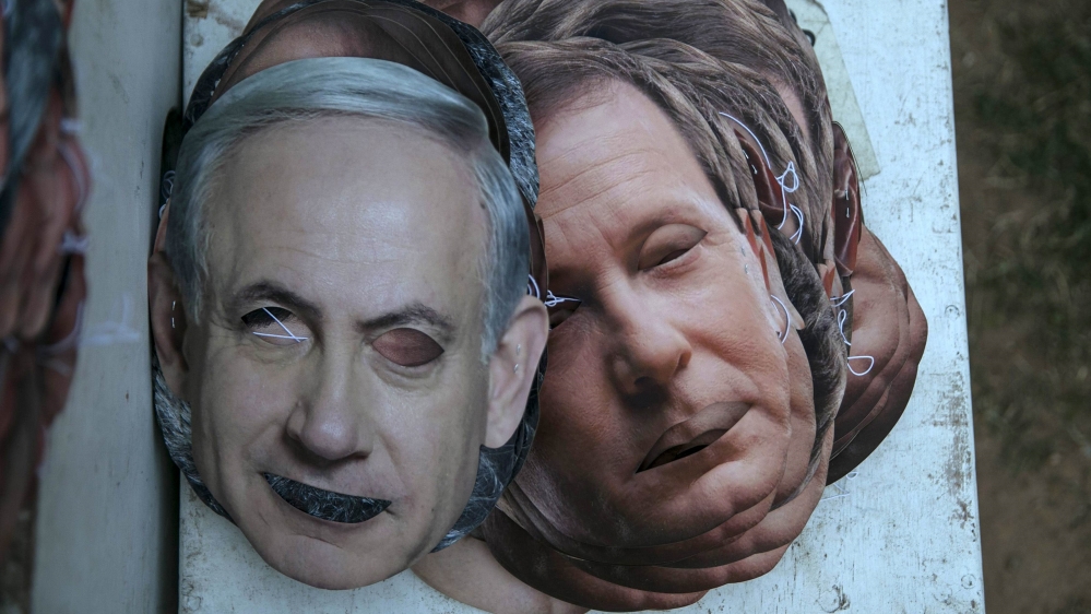 Masks depicting Israel''s Prime Minister Netanyahu and Isaac Herzog lie on the ground at the Yarkon park in Tel Aviv