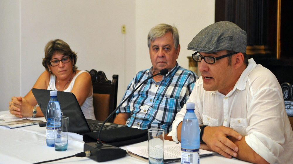Professor Carlos Alzugaray (centre) [EPA]