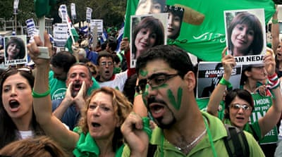 Protesters carry pictures of Neda Agha Soltan outside the United Nations headquarters [AP]