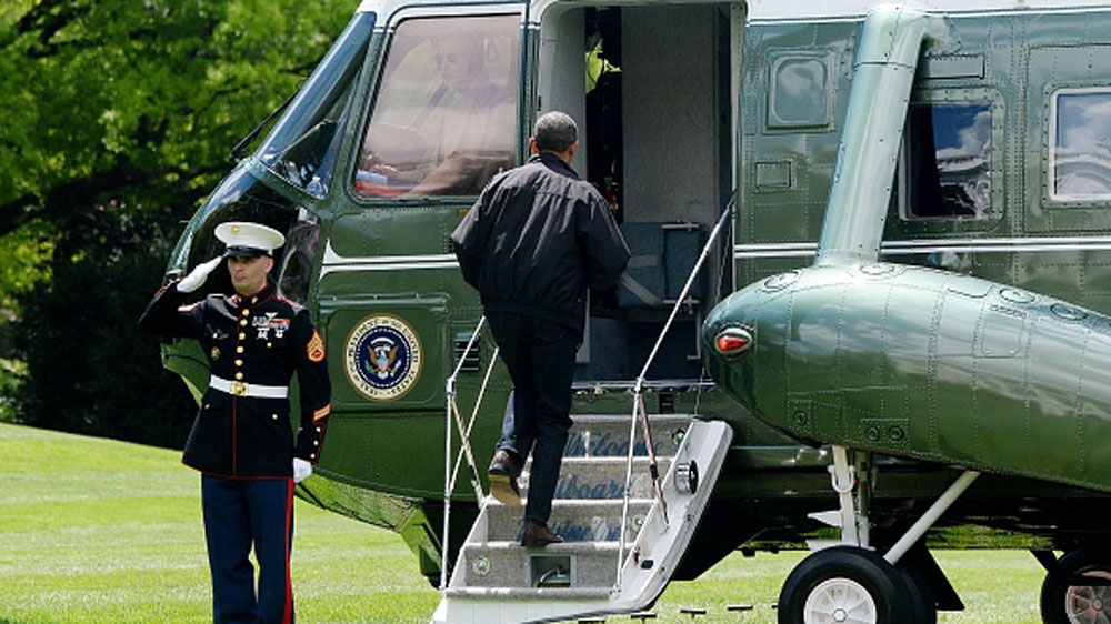 Obama walks on to Marine One on the South Lawn of the White House prior to his departure to Camp David [Getty]