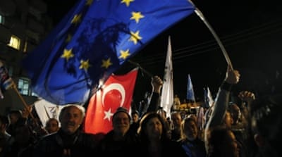 Supporters of Turkish Cypriots' newly elected leader, Mustafa Akinci, celebrate his win [AP]