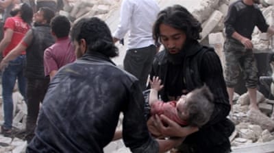 A boy is rescued from the debris of a building after barrel bomb attacks in Aleppo, Syria [Getty]
