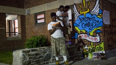 Boys stand near a makeshift memorial for Freddie Gray in Baltimore [REUTERS]